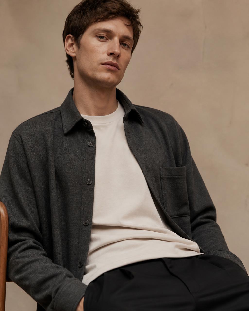 Man in a charcoal overshirt and off-white tee